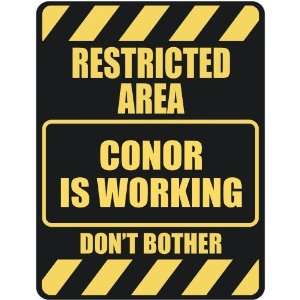  RESTRICTED AREA CONOR IS WORKING  PARKING SIGN