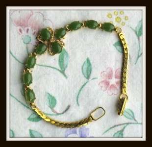 THIS IS A PRETTY GOLDTONE BRACELET WITH PRONGSET GREEN JADE, IT 