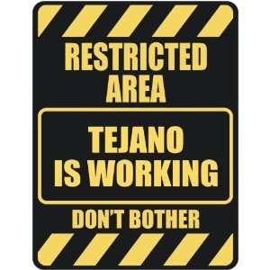   RESTRICTED AREA TEJANO IS WORKING  PARKING SIGN