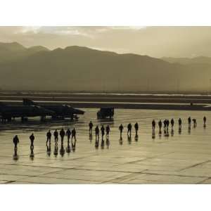  Silhouettes of Men and Planes on a Military Base Runway 
